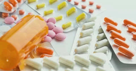 Close-up of many different turning pills. Packaging of tablets and pills on the Video stock 78542315