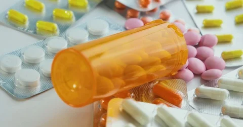 Close-up of many different turning pills. Packaging of tablets and pills on the Stock Footage 78543748