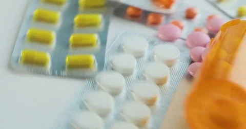 Close-up of many different turning pills. Packaging of tablets and pills on the Vídeo Stock 78544651