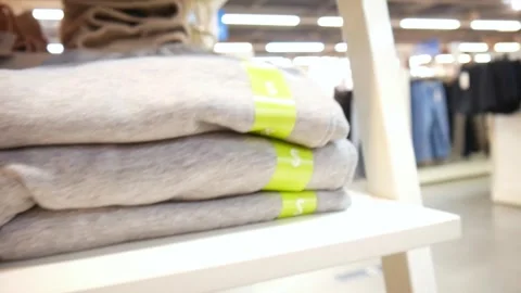 Close-up of many folded clothes sorted by colors and sizes in a clothing store Stock Footage 279019462