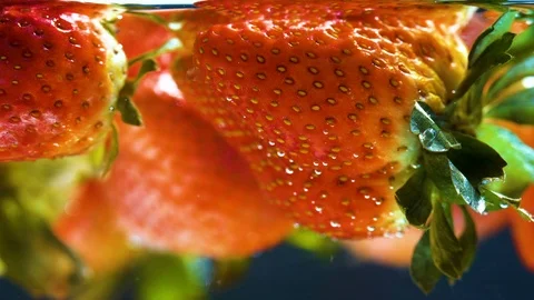 Close up, Many fresh berries float in water. Stock Footage 94663665