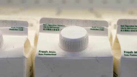 Close up of many fresh milk white boxes in a row in the supermarket fridge Video stock 166074465