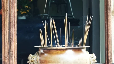Close up of many incense sticks burning at the entrance of a Buddhist temple Stock Footage 346418943