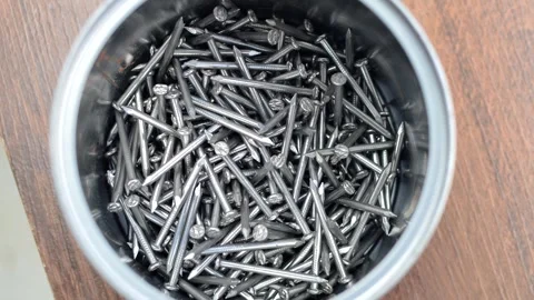 Close-up of many nails on a white surface, representing construction and ma.. Stock Footage 261099456