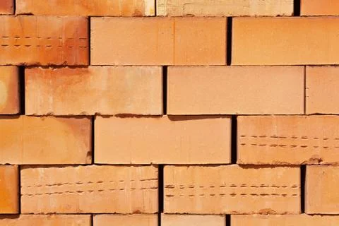 Close up many orange block bricks are stacked together Stock Photos
