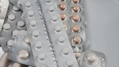 Close up, many packed pills rotating on white background Stock Footage 81462433