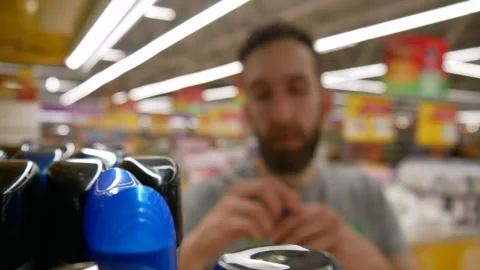 Close-up of many solid deodorants on a store shelf and a male buyer chooses one 스톡 동영상 240460864