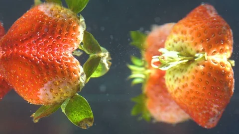 Close up, Many strawberries float on the surface slowly. Stock Footage 93101884