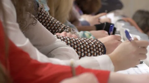 Close-up of many students participating in a lecture and taking notes Stock Footage 69928086