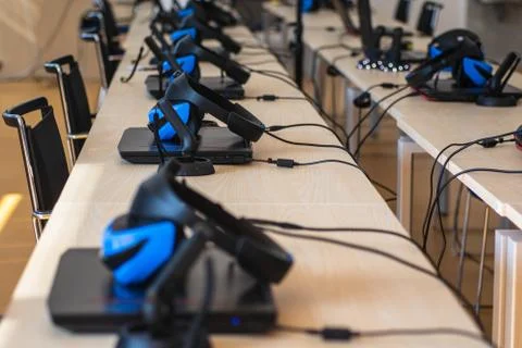 Close up of many virtual reality (VR) sets  in a classroom - headset, controller Stock Photos