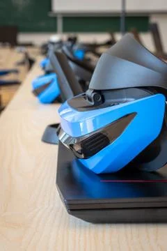 Close up of many virtual reality (VR) sets  in a classroom - headset, controller Stock Photos