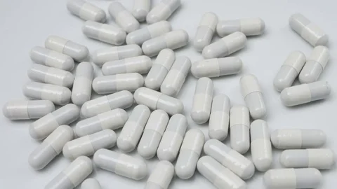Close up with many white pills rotating Stock Footage 81007485
