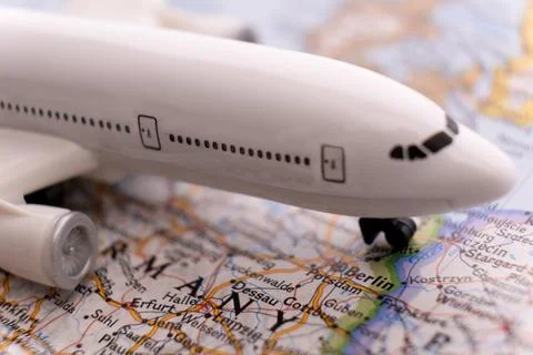 Close up of map with miniature plane highlighting Berlin, Germany through Foto stock