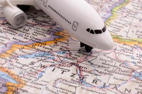 Close up of map with miniature plane highlighting Bern, Switzerland through 库存照片