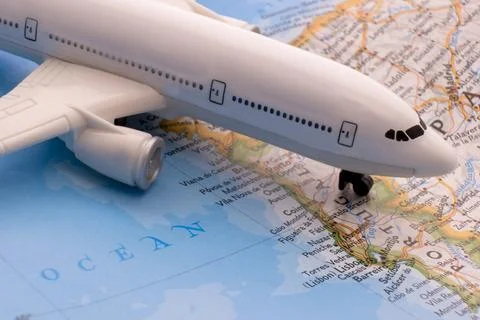 Close up of map with miniature plane highlighting Lisbon, Portugal through 库存照片