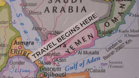Close Up of Map with Paper Label Reading Travel Begins Here over Yemen Stock Footage 346763850