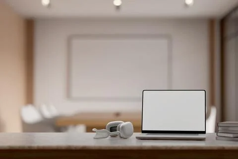 Close up of marble desk with blank screen laptop, headphones and books in b.. Stock Illustration