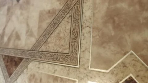 Close-up of a marble floor featuring an intricate inlay design with geometric Stock Photos