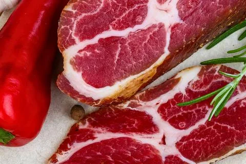Close up of marbled raw meat with red pepper and rosemary Stock Photos