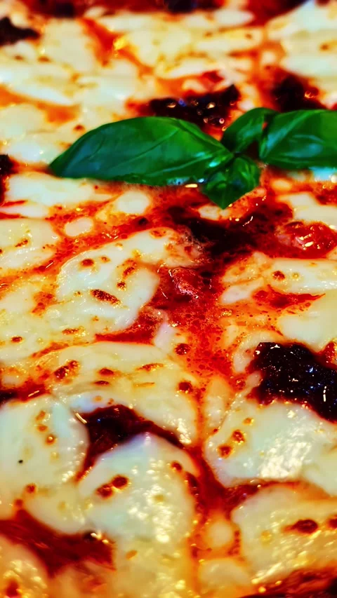 Close-up of a Margherita Pizza with Basil Topping Stock Footage 337929261