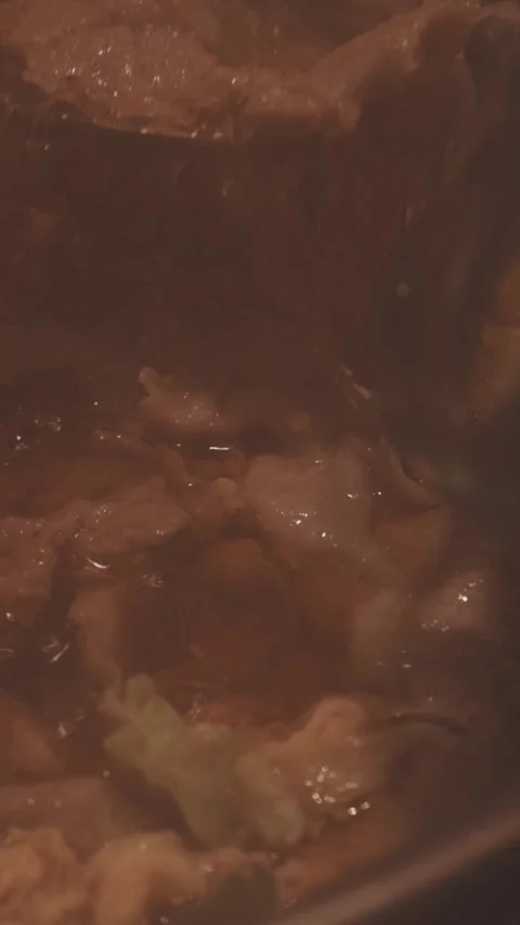 Close-up of marinated pork sizzling on a wire mesh gridiron over hot charcoal 库存影片 344921941
