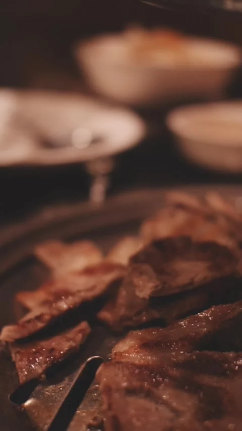 Close-up of marinated pork sizzling on a wire mesh gridiron over hot charcoal Stock Footage 344922114