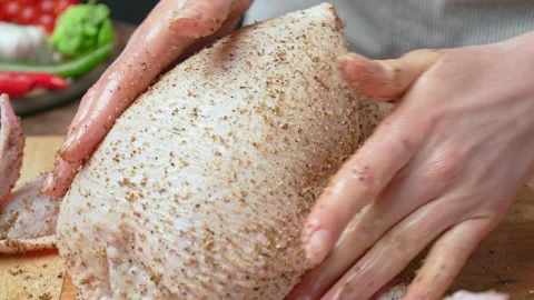 Close-up of marinating a whole raw chicken with black pepper, salt, coriander. Stock Footage 145105068
