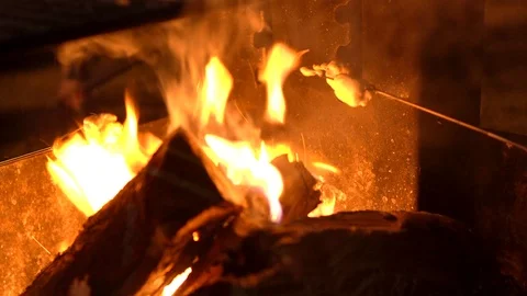 Close up marshmallows roasting over fire for campers s'mores Stock Footage 114260464