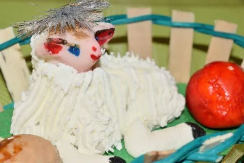 Close up of marzipan Easter lamb and fruit in a basket Stock Photos