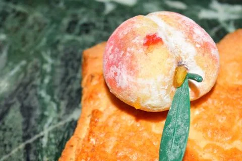 Close up of marzipan fruit in shape of peach Photos