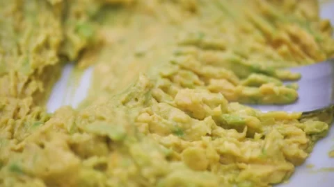 Close-up, mash an avocado with a fork. Preparation of guacamole sauce, chopping Stock Footage 221675799