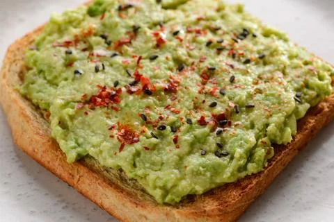 Close up on a mashed avocado toast Stock Photos