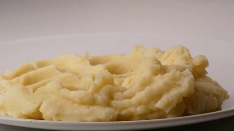 Close up. On mashed potatoes, put a spatula of fried bacon with onions and Stock Footage 107487447