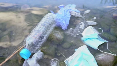 Close Up of Mask and Gloves Floating on the River. Environment Concept. Stock Footage 140404960