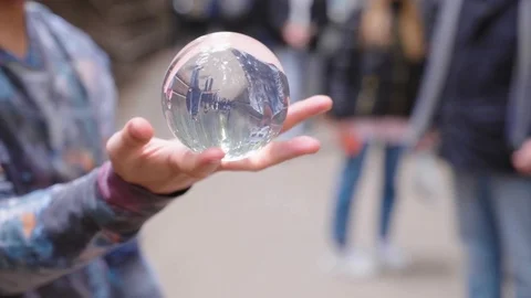 Close up of a masked magician performing a magic trick to a crowd at the Stock Footage 123389690