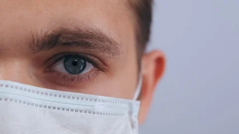 Close-up of the masked man's eye. 스톡 동영상 127118976