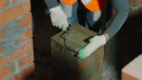 Close Up of Mason Applying Mortar During Brickwork Construction Stock Footage 343357427