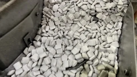 Close up of mass deburring process, vibrating with ceramic chips Stock Footage 202250825