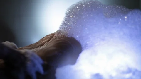 Close-up Massage of the buttocks and legs under the beautiful soapy foam in Stock Footage 115878037