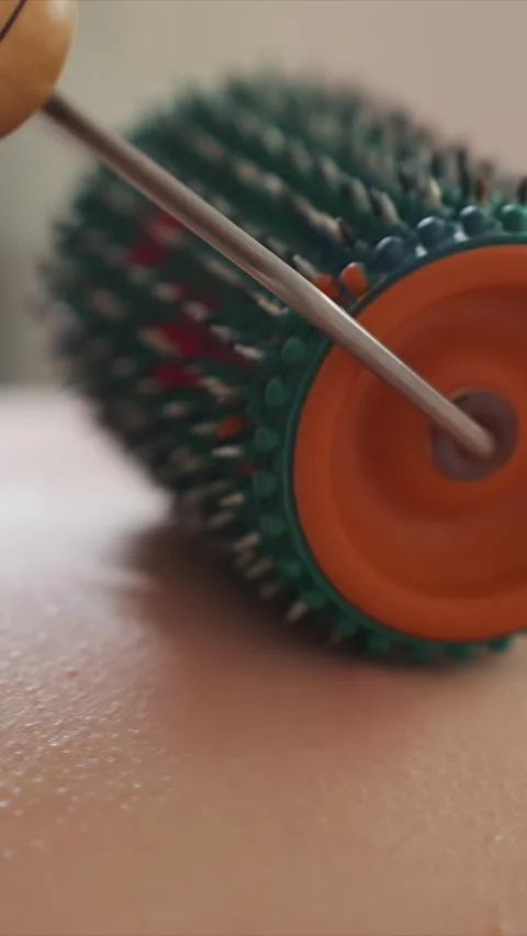 Close up of Massage Roller Tool Moving Over Skin Detail showing massager texture Vídeo Stock 346784319