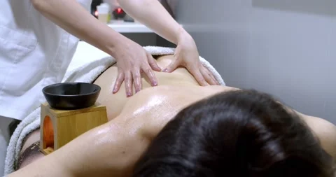 Close-up of masseur hands doing spinal massage Video stock 134933329