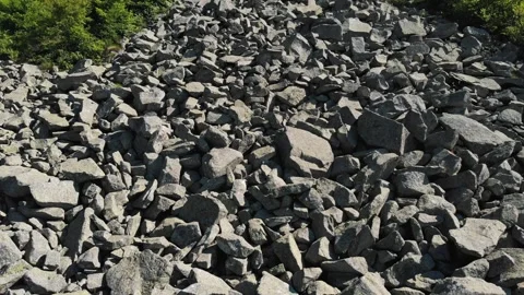 Close up of massive grey rocks and boulders after mountain rockfall in Alps Video stock 343794625