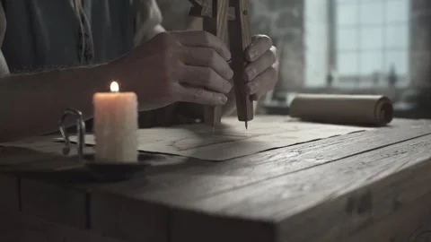 Close up of master hands checking an ornithopter blueprint with a divider 스톡 동영상 340079663