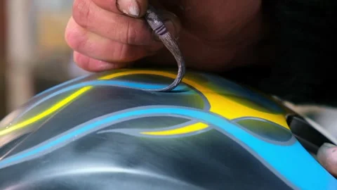 Close-up master hands,stained in paint,correcting airbrushing on motorcycle Stock Footage 275399395