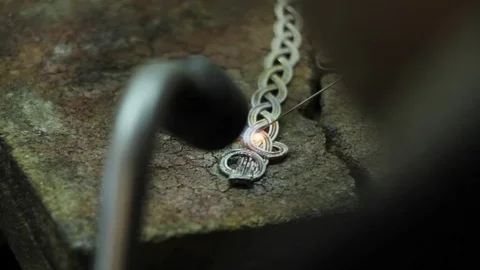 Close-up master jeweler makes a silver bracelet, hand-made silver jewelry Stock Footage 126726592