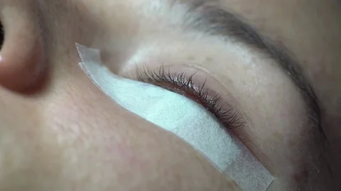 Close-up of master lash maker remove oil, preparing for eyelash extension Stock Footage 74854341