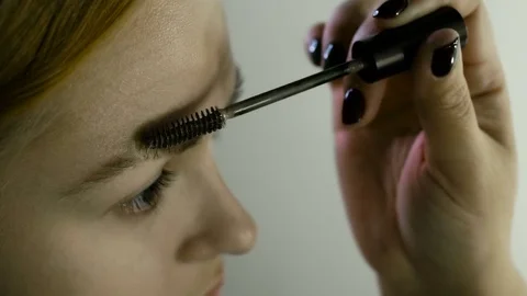 Close up. The master in a make-up prepares model for display. The girl puts with 스톡 동영상 82081300