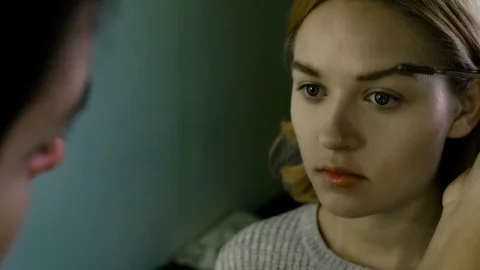 Close up. The master in a make-up prepares model for display. The girl puts with 스톡 동영상 82081430