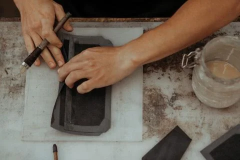 Close up of master making leather wallet with brush and glue. Handmade master at 库存照片