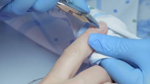 Close-up, Master Manicure Cuts off Katikuly on Girl's Finger Stock Footage 97957907